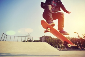 skateboarding  jumping at  sunrise skatepark